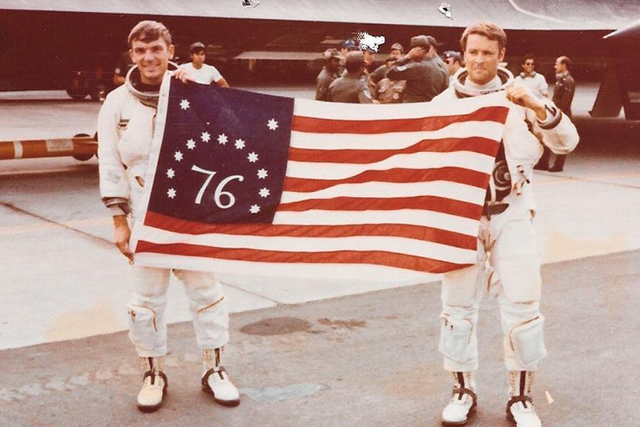 Airmen Al Joersz, left, and George Morgan hold a bicentennial American flag after breaking the world aviation speed record in 1976. (CNN)
