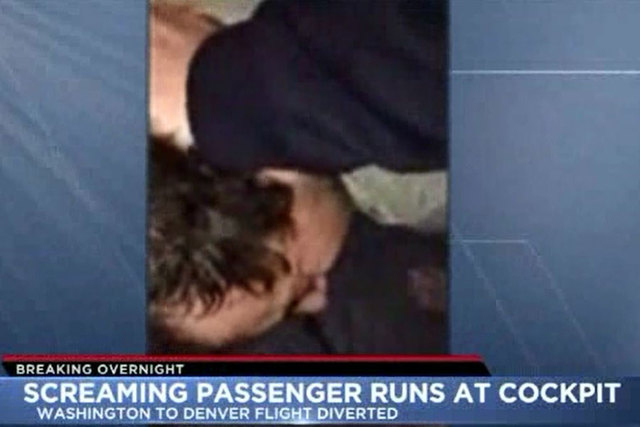 An unruly passenger was subdued on a flight from Washington, D.C., to Denver Monday night after he ran toward the cockpit screaming “jihad, jihad.” (Screengrab/KDVR-Denver)