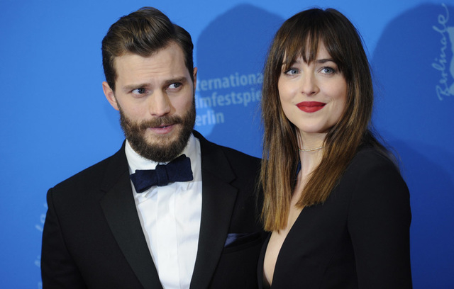 Actors Dakota Johnson and Jamie Dornan (L)  arrive for the screening of the movie 'Fifty Shades of Grey' at the 65th Berlinale International Film Festival in Berlin February 11, 2015. (REUTERS/Ste ...