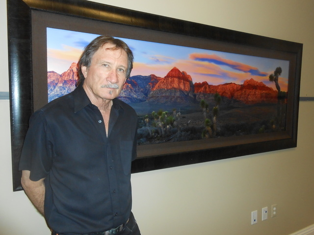 William Carr pauses Feb. 9, 2015, in his new Tivoli Village gallery before one of his photographs of Red Rock Canyon. A Summerlin resident, he often is out in nature to shoot landscapes. Carr said ...