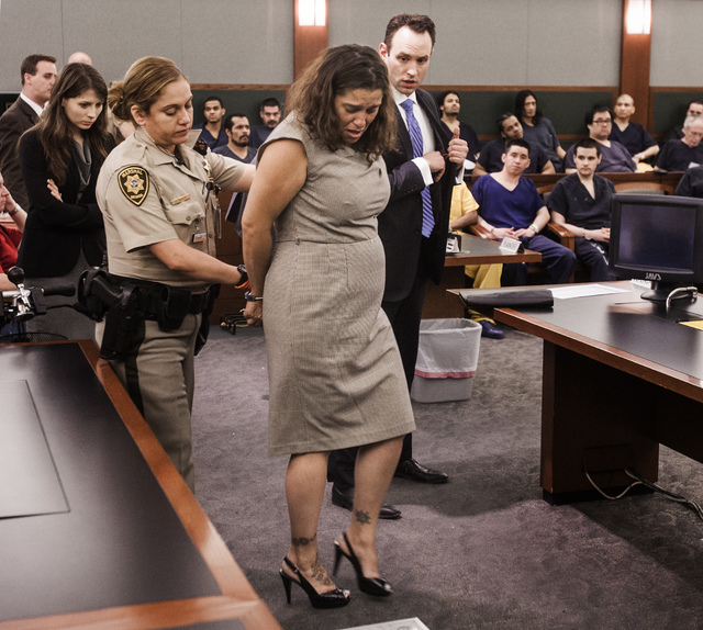 Patience Bristol is led away during her sentencing at Regional Justice Center on Wednesday, May 28, 2014. Bristol pleaded guilty tp exploitation of an elderly/vulnerable person and will serve thre ...