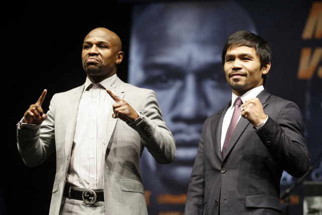 Eleven-time, five-division world boxing champion Floyd "Money" Mayweather (L) and eight-division world champion Manny "Pac-Man" Pacquiao pose at a news conference. (Lucy Nicholson/Reuters)