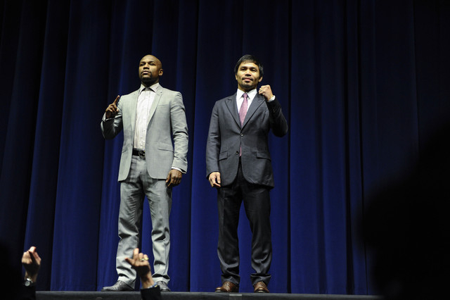 Floyd Mayweather Jr. and Manny Pacquiao pose for photographers during a press conference to announce their May 2 fight during a press conference at the Nokia Theater in Los Angeles on March 11. (R ...