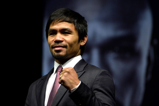 Mar 11, 2015; Los Angeles, CA, USA; Manny Pacquiao poses for photographers during a press conference to announce their fight on May 2, 2015 at the Nokia Theater in Los Angeles. Mandatory Credit: R ...
