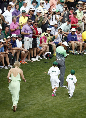 Apr 8, 2015; Augusta, GA, USA; Tiger Woods and his children Sam Woods and Charlie Woods and girlfriend Lindsey Vonn walk to the 8th hole during the Par 3 Contest prior to the 2015 The Masters golf ...