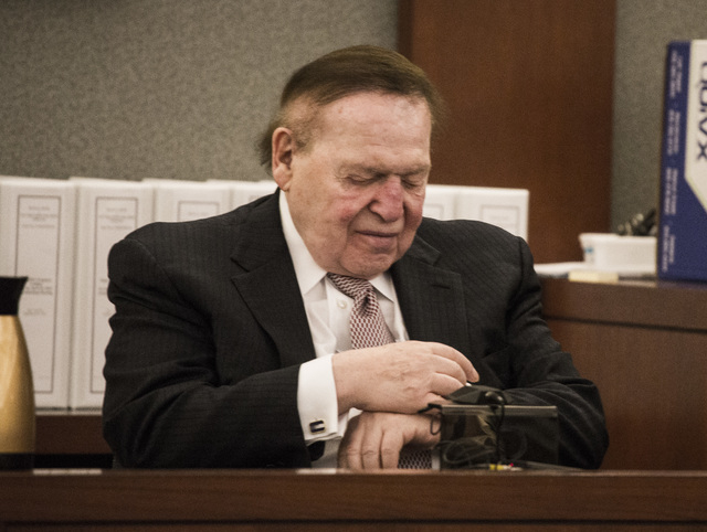 Las Vegas Sands Corp. Chairman and CEO Sheldon Adelson,  checks his watch while taking the  witness stand at Clark County Justice Center on Tuesday, April 28,2015.   Steven Jacobs, former presiden ...