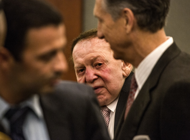 Las Vegas Sands Corp. Chairman and CEO Sheldon Adelson, center,before taking the  witness stand at Clark County Justice Center on Tuesday, April 28,2015.  Steven Jacobs, former president of Sands  ...