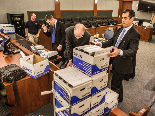 Paralegal Paul Garcia unloads boxes during Steven Jacobs,  former president of Sands Macau, wrongful termination case against Sands China and Las Vegas Sands Corp. at Clark County Justice Center o ...