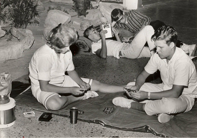Beatles fans read and play cards to pass the time while while camping out overnight outside the Las Vegas Convention Center on June 29, 1964 to buy tickets for the Beatles concerts. (Terry Todd/La ...