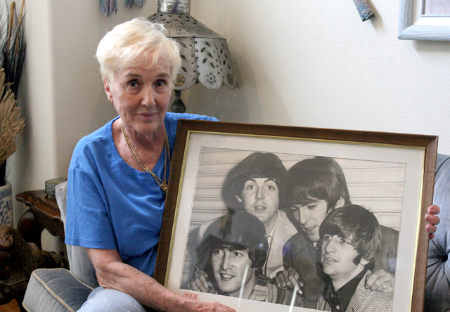 Barbara Eddowes holds a photo of The Beatles taken while she and her daughter, Sherri, were backstage after one of The Beatles’ Las Vegas shows. They attended one of The Beatles’ two Las Vegas ...
