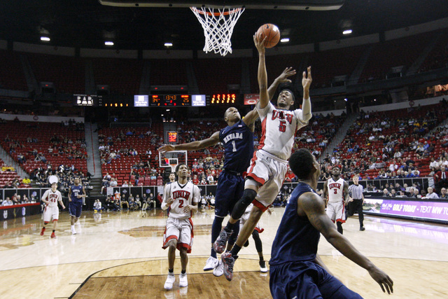 UNLV forward Chris Wood drives past UNR guard Marqueze Coleman for a basket during the second half of their Mountain West Conference tournament game Wednesday, March 11, 2015, at the Thomas & Mack ...