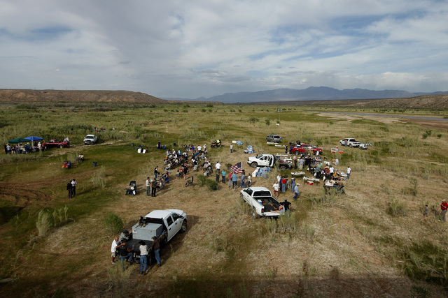 People gather along the Virgin River during a rally in support of Cliven Bundy near Bunkerville, Nev. Friday, April 18, 2014. (John Locher/Las Vegas Review-Journal)