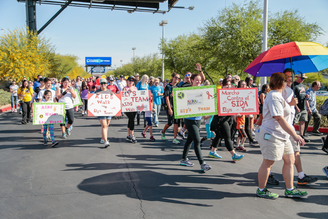 Participants carrying team signs, walk the course during the Aid for AIDS of Nevada (AFAN) 25th Annual AIDS Walk Las Vegas at Town Square Las Vegas, South Las Vegas Boulevard,  Las Vegas, Sunday,  ...