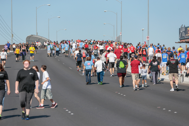 A crowd of participants walk across the overpass on W. Sunset road as part of the course for the Aid for AIDS of Nevada (AFAN) hosts the 25th Annual AIDS Walk Las Vegas at Town Square Las Vegas, S ...