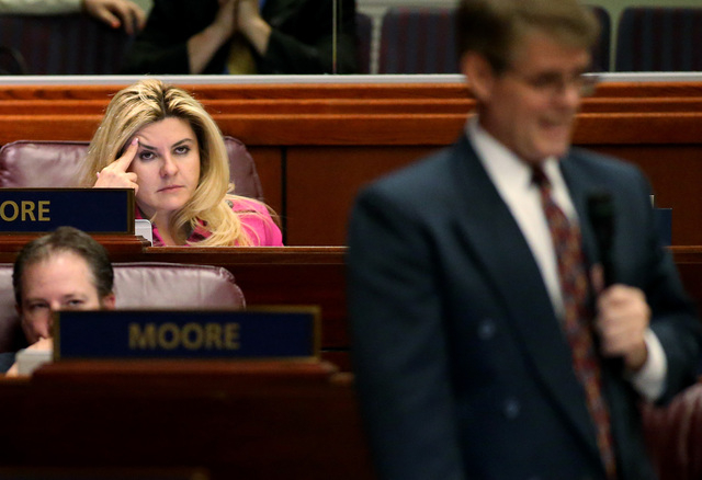 Nevada Assembly Republicans Michele Fiore and John Moore listen as Chris Edwards speaks on the Assembly floor at the Legislative Building in Carson City, Nev., on Tuesday, April 21, 2015. (Cathlee ...