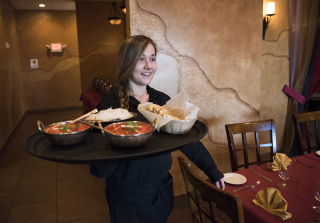 Server Jessica Owens brings out dishes to customers at Saffron Flavors of India, 4450 N. Tenaya Way, March 27, 2015. (Martin S. Fuentes/View) (Click for more photos)