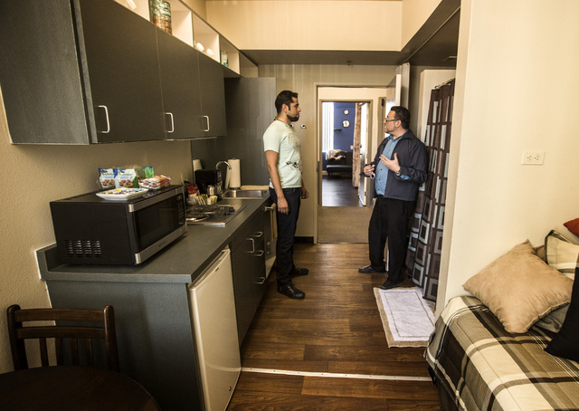 Community manager Giovanni Bellante, right, shows potential tenant Rodrigo Adame  a model apartment in 211 at 211 8th Street on Thursday, April 16, 2015. Downtown Project will soon be renting smal ...