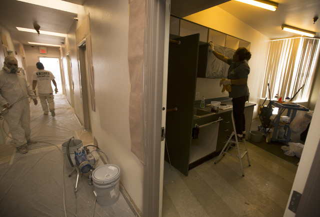 Workers prep the fourth floor of 211 at  211 8th Street on Thursday, April 16, 2015. Downtown Project will soon be renting small renovated apartments in the 315­-unit complex in downtown Las  ...