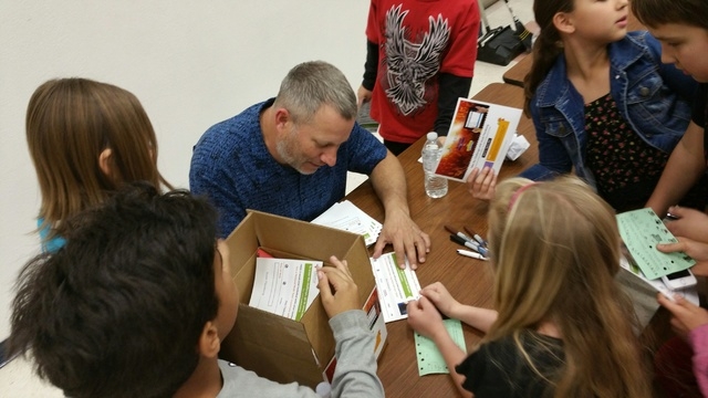Scott Flansburg signs autographs March 12, 2015, after giving a presentation on The Human Calculator at Ober Elementary School, 3035 Desert Marigold Lane. He represented Tabtor, which has a tablet ...