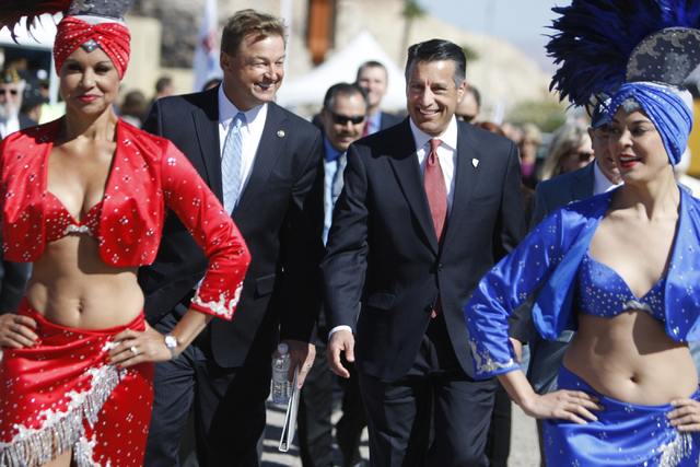 U.S. Sen. Dean Heller, R-Nev., left, and Nevada Gov. Brian Sandoval, make their way to their seats for the ground breaking ceremony for the I-11 Boulder City bypass project in Boulder City, Nev., ...