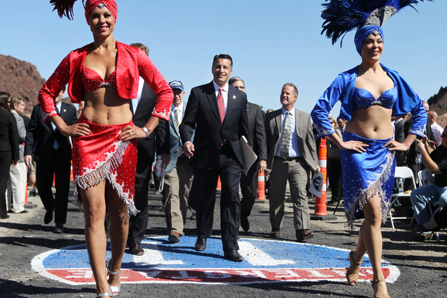 Nevada Gov. Brian Sandoval, center, makes his way to his seat for the ground breaking ceremony for the I-11 Boulder City bypass project in Boulder City, Nev., Monday, April 6, 2015. (Erik Verduzco ...