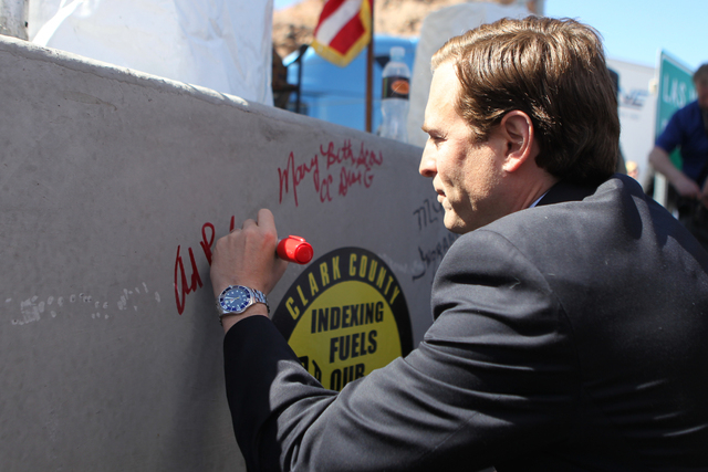 Nevada Attorney General Adam Laxalt signs a concrete box culvert during the ground breaking ceremony for the I-11 Boulder City bypass project in Boulder City, Nev., Monday, April 6, 2015. (Erik Ve ...