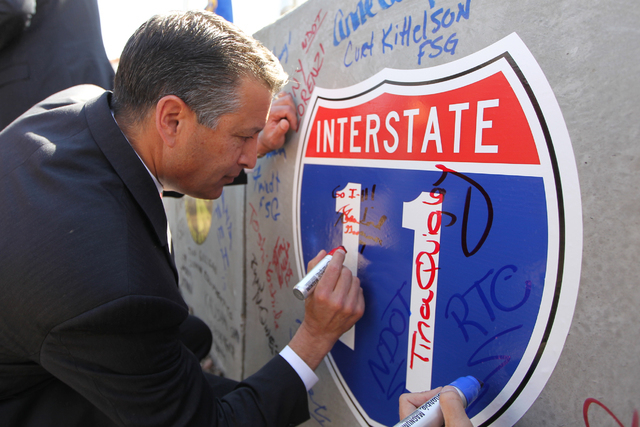 Nevada Gov. Brian Sandoval signs a concrete box culvert during the ground breaking ceremony for the I-11 Boulder City bypass project in Boulder City, Nev., Monday, April 6, 2015. (Erik Verduzco/La ...