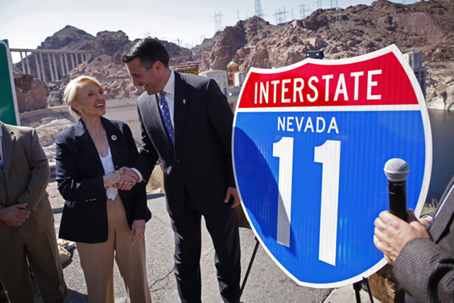 Nevada Governor Brian Sandoval, right, and Arizona Governor Jan Brewer shake hands on the Arizona side of Hoover Dam Friday, March 21, 2014 during an event to call attention to efforts to develop  ...