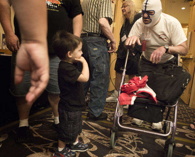 Former professional wrestler Dick Beyer,right, aka The Destroyer, aka Dr. X. talks to fight fan Braden Watkins,5, during the  Cauliflower Alley Club convention at the Gold Coast Hotel and Casino L ...