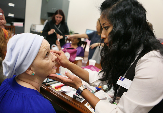 Lia Yulianti, right, applies makeup to Christine Hernandez during a Look Good Feel Better class at 21st Century Oncology March 24, 2015. The program, administered by the American Cancer Society, i ...