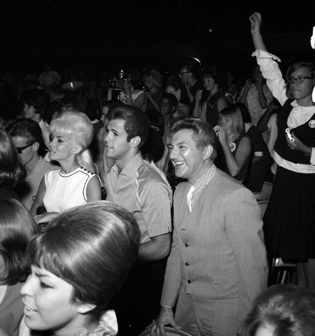 Liberace smilies along with adoring fans of The Beatles as they perform on stage at the Las Vegas Convention Center on Aug. 20, 1964. (Courtesy Photo/Las Vegas Convention and Visitors Authority)