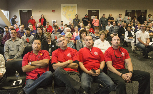 Members of the Professional Firefights of Nevada union listen during the Assembly Ways and Means Committee telecast hearing on AB190 hearing Wednesday, April 15, 2015, at the Sawyer Building, 555  ...