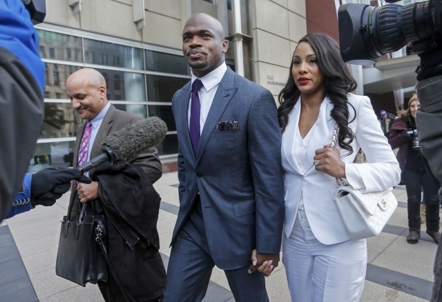 Minnesota Vikings running back Adrian Peterson leaves the U.S. District Courthouse with his wife, Ashley Brown Peterson, on Feb 6, 2015. (Bruce Kluckhohn-USA TODAY)