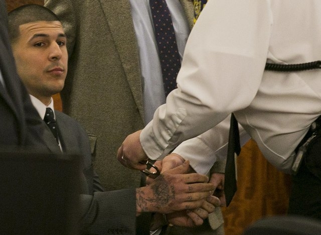A court officer places handcuffs on the wrists of former NFL player Aaron Hernandez after the guilty verdict was read during his murder trial at the Bristol County Superior Court in Fall River, Ma ...