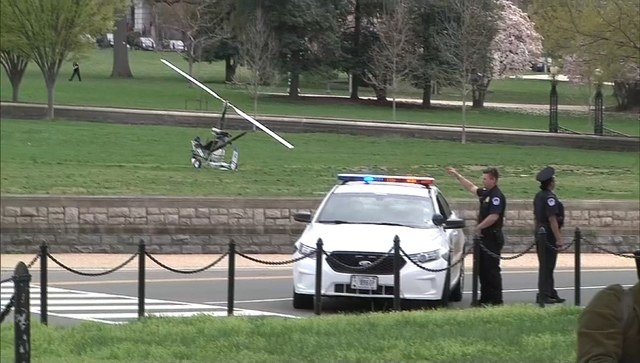 A small helicopter (L) is pictured in this still image taken from video after it landed on the west lawn of the U.S. Capitol in Washington April 15, 2015. One person was detained and nearby street ...
