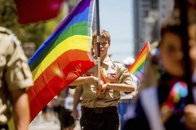 Boy Scout Casey Chambers carries a rainbow flag during the San Francisco Gay Pride Festival in California, June 29, 2014. (Reuters/Noah Berger)