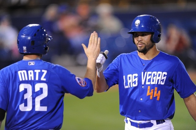 Las Vegas 51s outfielder Cory Vaughn (44) high fives starting pitcher Steven Matz after scoring a run in the fourth inning of their Triple-A minor league baseball game against the Oklahoma City Do ...