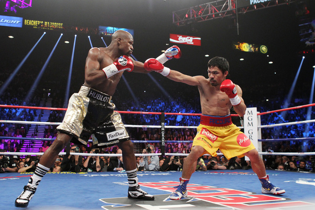 Floyd Mayweather Jr. and Manny Pacquiao feel each other out early in their welterweight unification boxing match at the MGM Grand Garden Arena in Las Vegas on Saturday, May 2, 2015. (Sam Morris/La ...