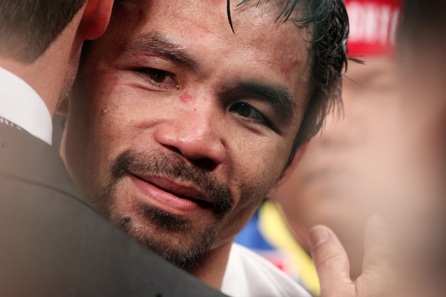 Manny Pacquiao gets a hug after his welterweight unification boxing match against Floyd Mayweather Jr. at the MGM Grand Garden Arena in Las Vegas on Saturday, May 2, 2015. (Sam Morris/Las Vegas Re ...