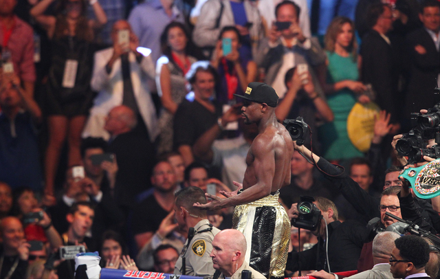 Floyd Mayweather Jr. acknowledges the crowd following his fight with Manny Pacquiao in their welterweight unification boxing match at the MGM Grand Garden Arena in Las Vegas on Saturday, May 2, 20 ...