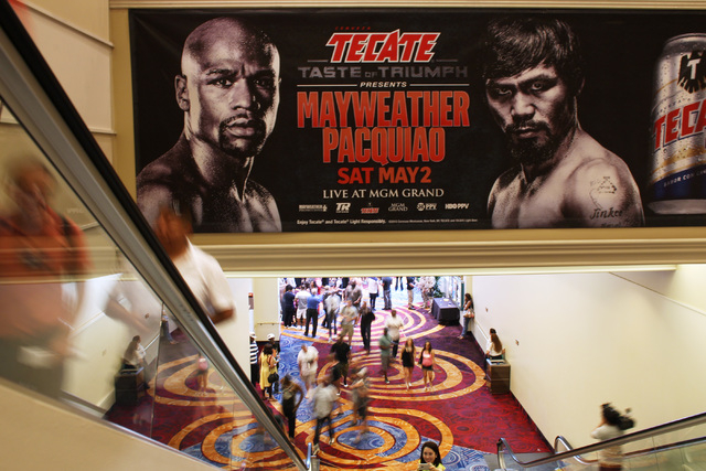 Fans head up the escalator for the Floyd Mayweather Jr. and Manny Pacquiao weigh in for their welterweight unification fight Friday, May 1, 2015, at the MGM Grand Garden Arena. (Sam Morris/Las Veg ...
