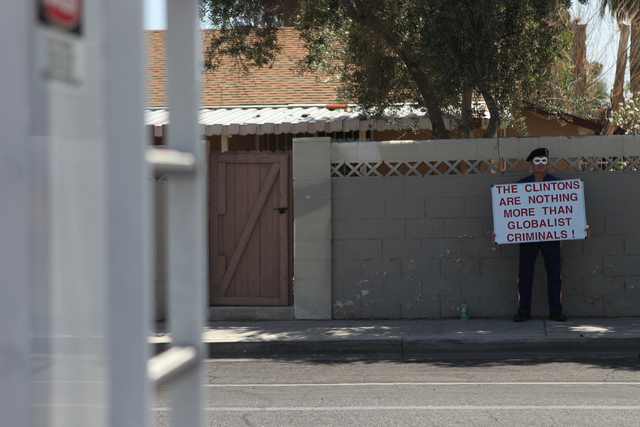 An unidentified protester stands outside of Rancho High School in North Las Vegas during a campaign visit by Democratic presidential candidate Hillary Clinton Tuesday, May 5, 2015. (Erik Verduzco/ ...