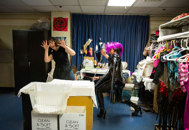 Wardrobe supervisor Holly McKinnis, left, and "Crazy Girls" dancer Rachel Schiferl (cq) joke around while Schiferl (cq) waits to dance in a dominatrix costume Friday, Feb. 14, 2014 at th ...