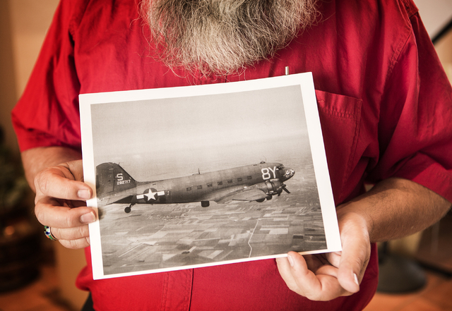 Mark Hall-Patton, administrator of Clark County Museum, 1830 S. Boulder Highway, in Henderson, holds a photo on Thursday, May 7, 2015, of the C-47 transport plane that 1st Lt. Howard Cannon co-pil ...