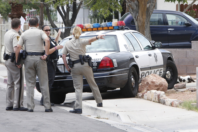 Las Vegas Metro police are seen at the 4700 block of Sheppard Drive to investigate a call of 2 dogs that attacked and bit a citizen Thursday, May 21, 2015. Arriving officers subsequently encounter ...