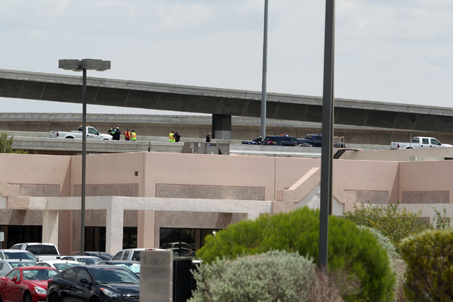Officials from the Nevada Department of Transportation and Nevada Highway Patrol troopers investigate possible damage on the ramp from southbound U.S. Route 95 to southbound Interstate 15 on Frida ...