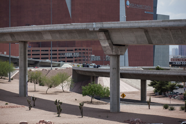 Officials from the Nevada Department of Transportation and Nevada Highway Patrol investigate possible damage on the ramp from southbound U.S. Route 95 to southbound Interstate 15 on Friday, May 22 ...
