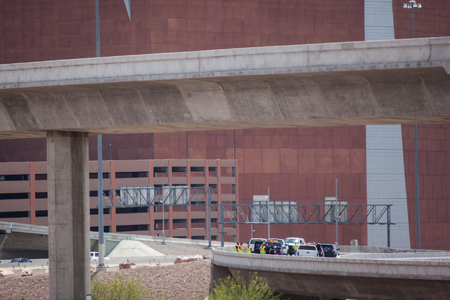 Officials from the Nevada Department of Transportation and Nevada Highway Patrol investigate possible damage on the ramp from southbound U.S. Route 95 to southbound Interstate 15 on Friday, May 22 ...
