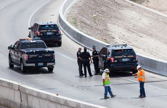 Officials from the Nevada Department of Transportation and Nevada Highway Patrol investigate possible damage on the ramp from southbound U.S. Route 95 to southbound Interstate 15 on Friday, May 22 ...