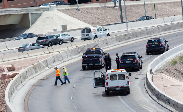 Officials from the Nevada Department of Transportation and Nevada Highway Patrol investigate possible damage on the ramp from southbound U.S. Route 95 to southbound Interstate 15 on Friday, May 22 ...